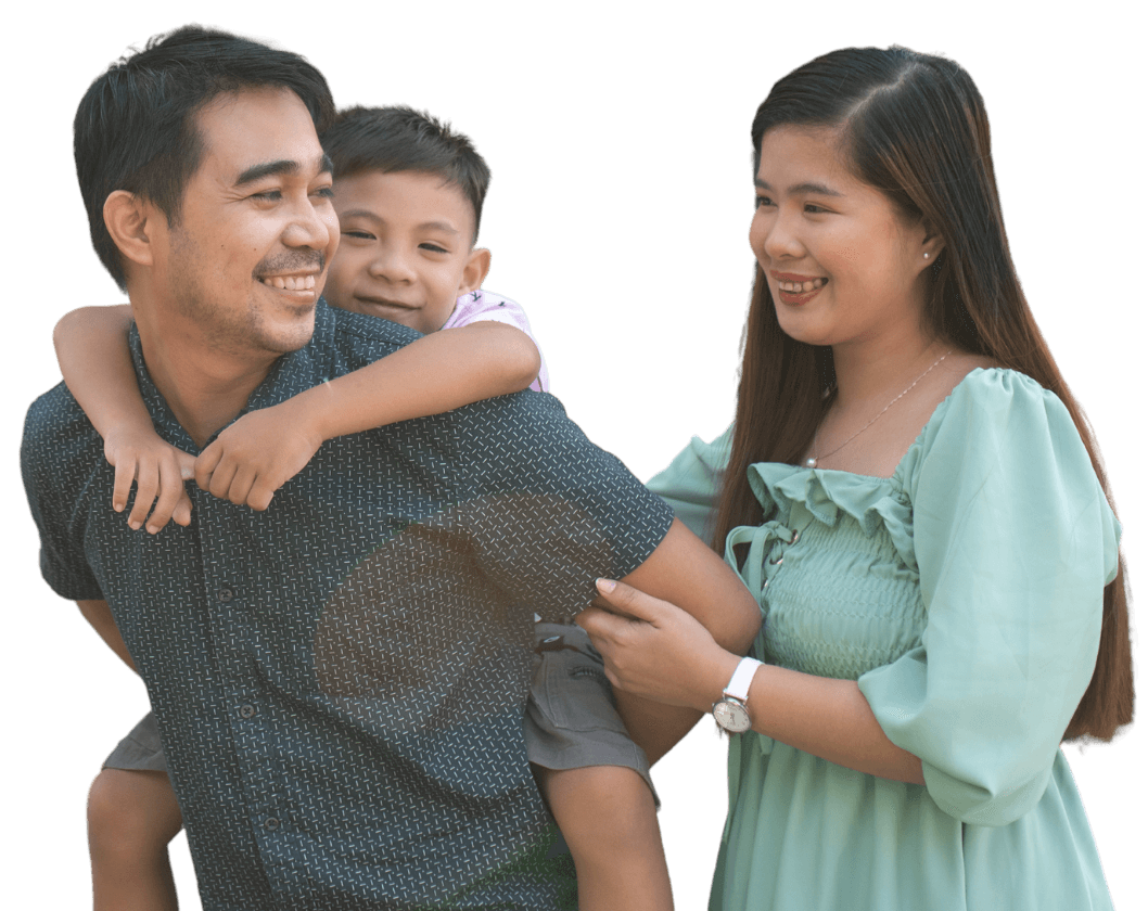 Happy Filipino family — father carrying child with mother beside them